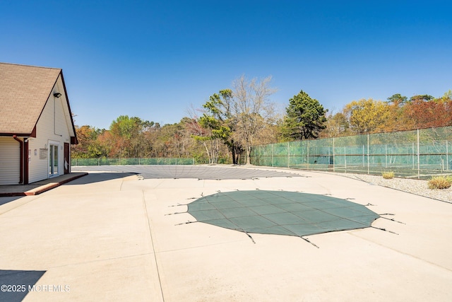 view of pool featuring a patio, fence, and a covered pool