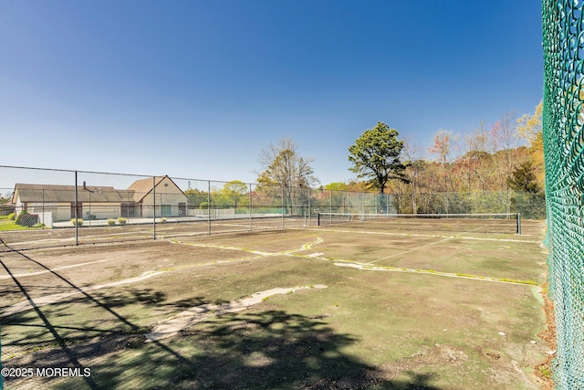 view of sport court featuring fence