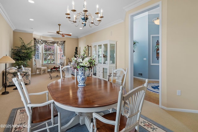 dining space with carpet, baseboards, recessed lighting, crown molding, and a chandelier