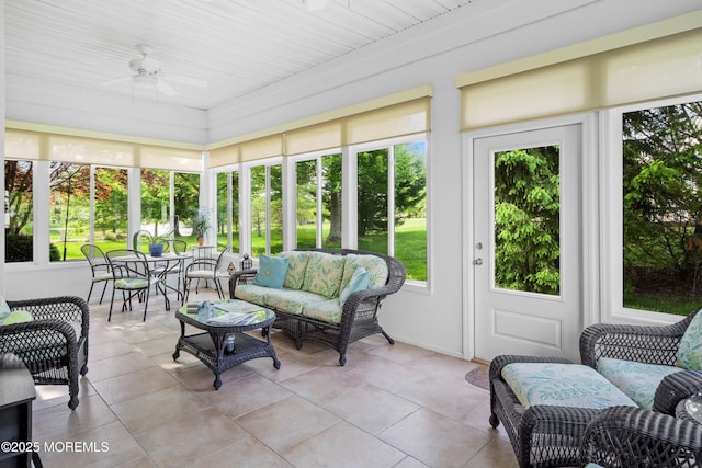 sunroom with plenty of natural light, a ceiling fan, and outdoor lounge area