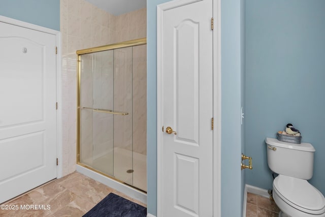 full bathroom with a shower stall and toilet