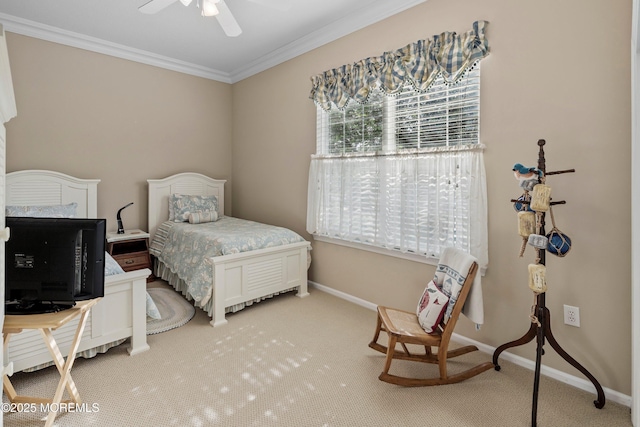 bedroom featuring crown molding, carpet, baseboards, and a ceiling fan