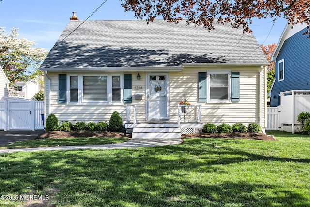 view of front of property featuring fence, a chimney, a gate, and a front yard