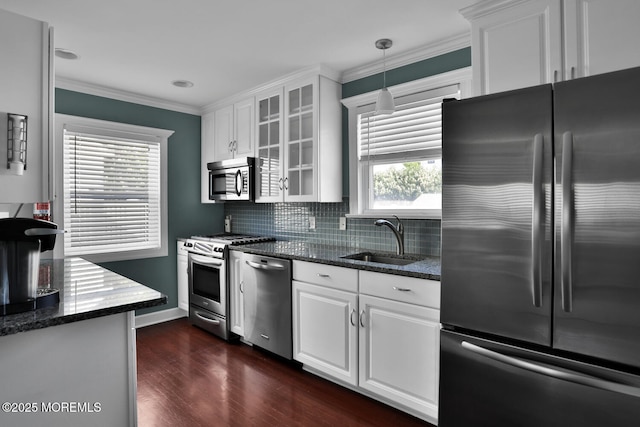 kitchen with a sink, dark wood-style flooring, appliances with stainless steel finishes, and white cabinets