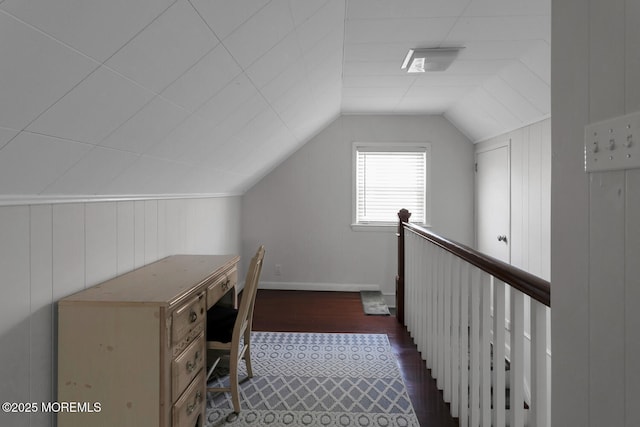 office area featuring baseboards, hardwood / wood-style floors, and lofted ceiling