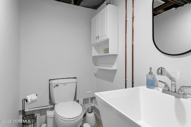 bathroom with toilet and a sink