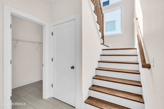 stairway with tile patterned flooring