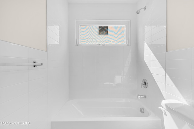 bathroom featuring toilet and shower / bathing tub combination
