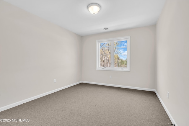 carpeted spare room with baseboards and visible vents