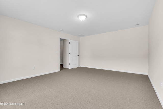 spare room with carpet flooring and baseboards
