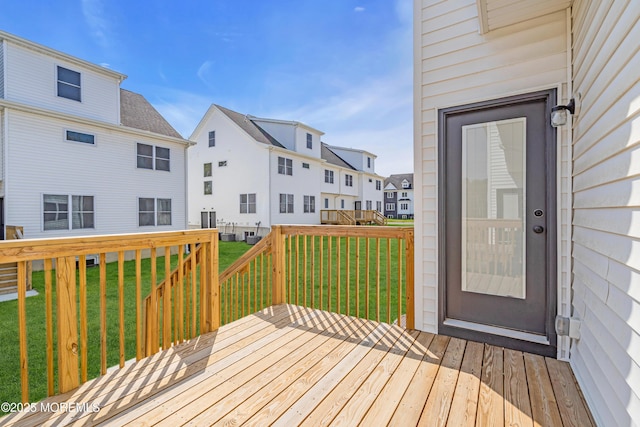 deck featuring a residential view and a yard