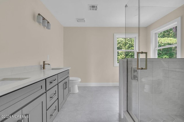 bathroom with visible vents, double vanity, toilet, a sink, and a stall shower