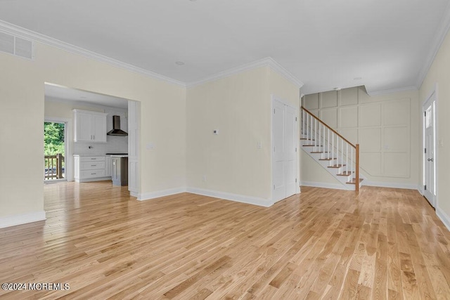 unfurnished living room featuring light wood-style floors, baseboards, visible vents, ornamental molding, and stairway