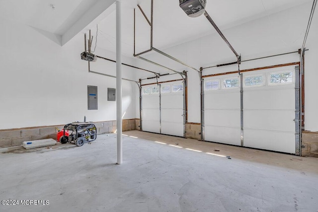 garage with a garage door opener and electric panel
