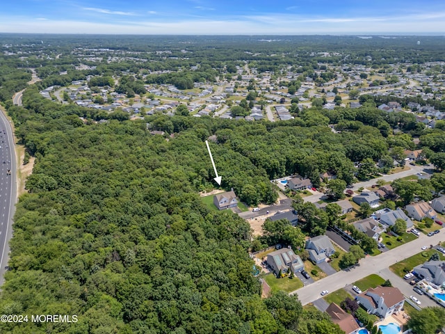 drone / aerial view featuring a view of trees