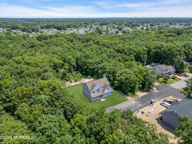 drone / aerial view with a wooded view