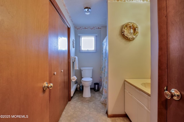 full bathroom with vanity, toilet, and baseboards