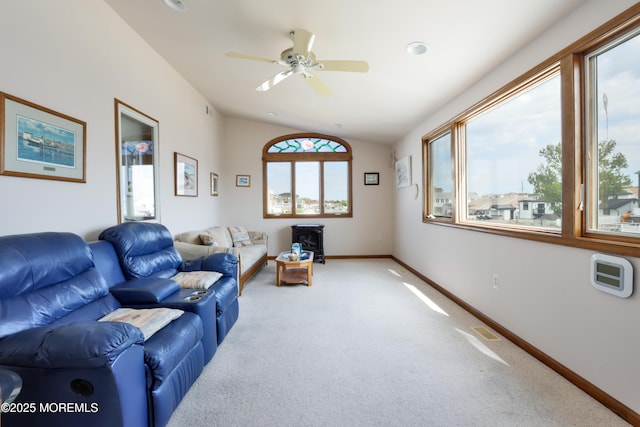 living room with lofted ceiling, light carpet, a ceiling fan, and baseboards