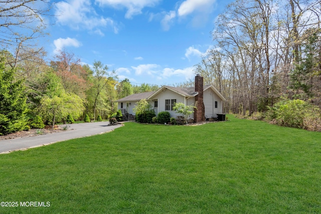 86 Cox Cro Rd, Toms River, NJ 08755 - view of side of property featuring a lawn, driveway, a chimney, and central air condition unit