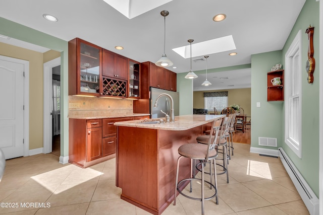 86 Cox Cro Rd, Toms River, NJ 08755 - kitchen with backsplash, visible vents, a skylight, baseboard heating, and light stone counters