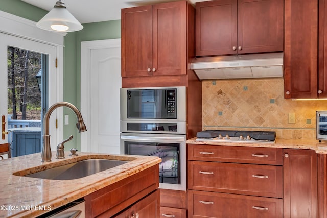 86 Cox Cro Rd, Toms River, NJ 08755 - kitchen with under cabinet range hood, tasteful backsplash, light stone counters, a sink, and appliances with stainless steel finishes