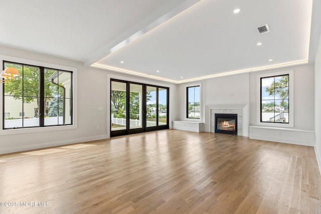 24 Baruch Dr, Long Branch, NJ 07740 - unfurnished living room featuring plenty of natural light, light wood finished floors, recessed lighting, and a glass covered fireplace