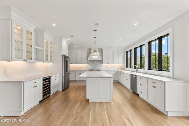24 Baruch Dr, Long Branch, NJ 07740 - kitchen featuring wine cooler, stainless steel appliances, a kitchen island, premium range hood, and decorative backsplash