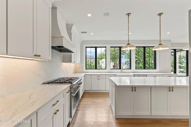 24 Baruch Dr, Long Branch, NJ 07740 - kitchen with high end stainless steel range, custom range hood, plenty of natural light, light wood-type flooring, and recessed lighting
