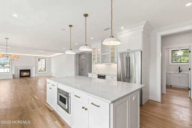 24 Baruch Dr, Long Branch, NJ 07740 - kitchen featuring healthy amount of natural light, light wood-style flooring, a center island, white cabinetry, and recessed lighting