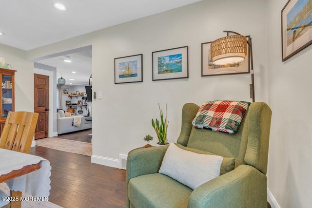 sitting room featuring baseboards, recessed lighting, and wood finished floors