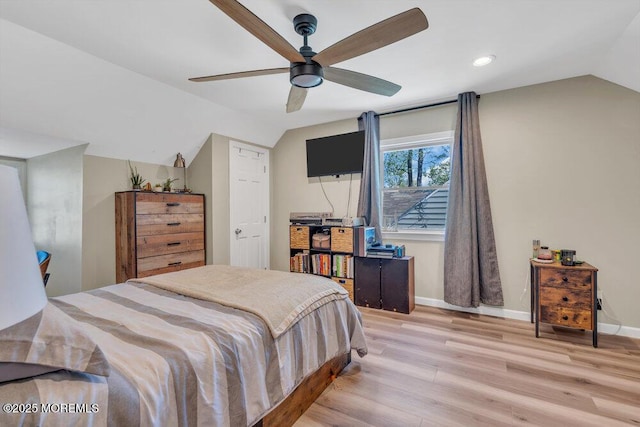 bedroom with baseboards, wood finished floors, and lofted ceiling