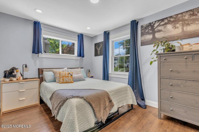bedroom with baseboards, recessed lighting, and wood finished floors