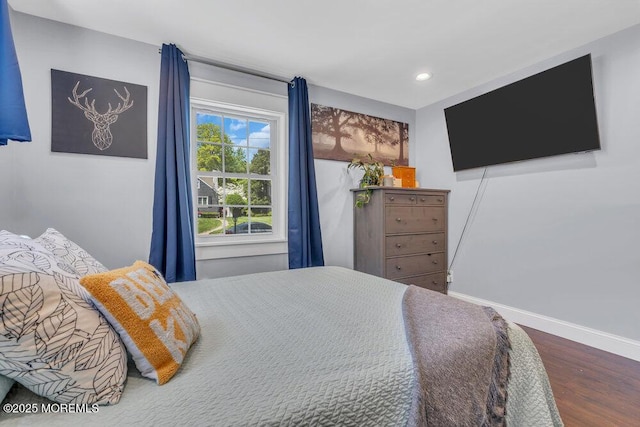 bedroom with baseboards, recessed lighting, and wood finished floors