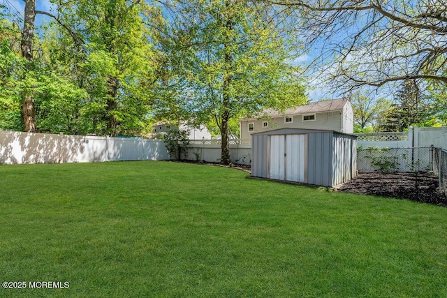 view of yard featuring a fenced backyard, a storage unit, and an outdoor structure