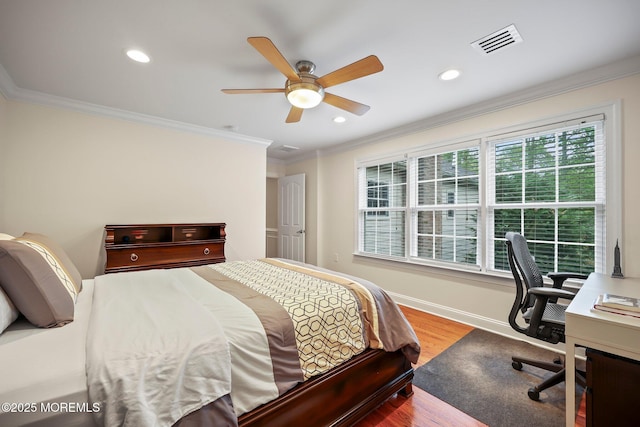 bedroom featuring ornamental molding, wood finished floors, recessed lighting, a desk, and a ceiling fan