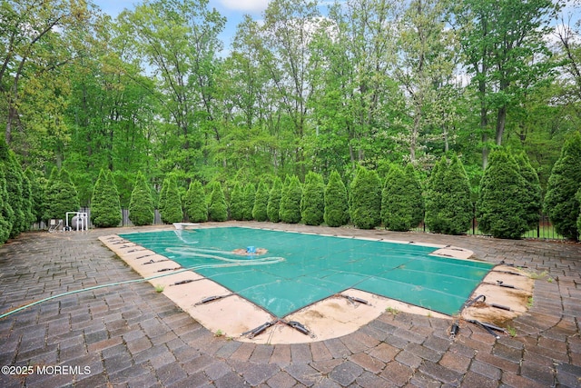 view of pool featuring a patio, a diving board, and a covered pool