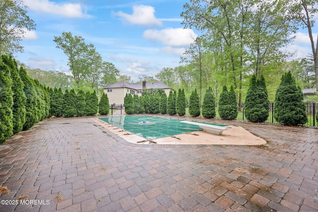 view of swimming pool featuring fence