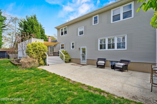 rear view of property featuring a yard and a patio area