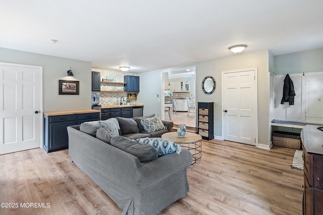 living room featuring baseboards and light wood-style flooring