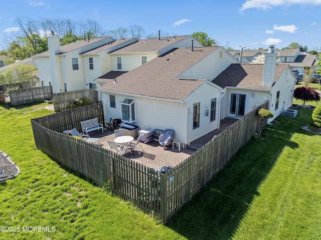 rear view of property with a yard, a patio area, a fenced backyard, and a residential view