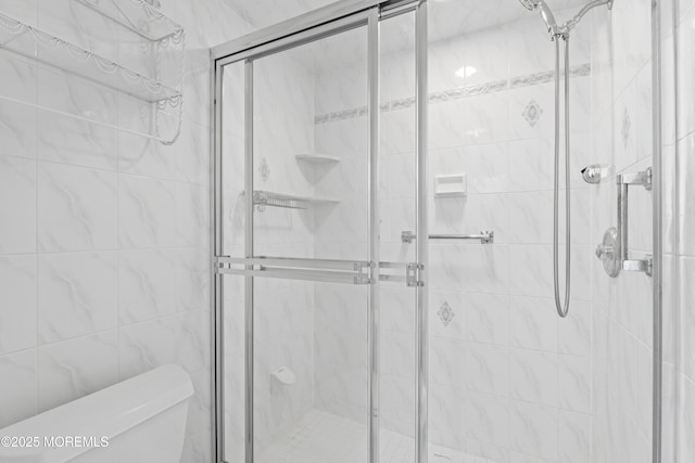 full bath with a stall shower and toilet