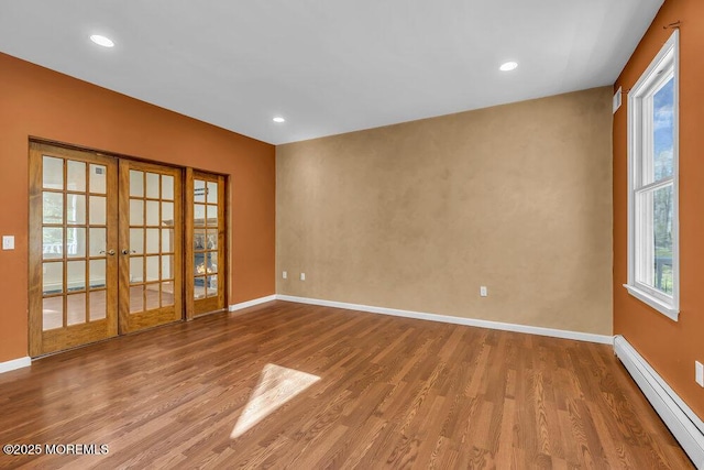 65 Pineoaka Rd, Jackson, NJ 08527 - spare room featuring baseboards, french doors, baseboard heating, and wood finished floors
