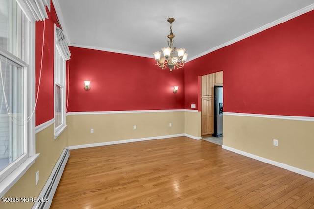 65 Pineoaka Rd, Jackson, NJ 08527 - unfurnished room featuring an inviting chandelier, baseboards, wood finished floors, a baseboard heating unit, and ornamental molding
