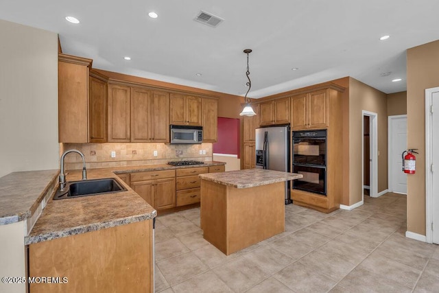 65 Pineoaka Rd, Jackson, NJ 08527 - kitchen featuring appliances with stainless steel finishes, a sink, backsplash, visible vents, and a kitchen island