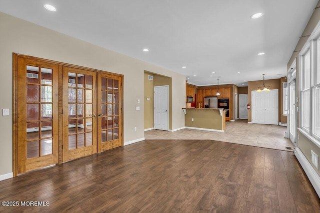 65 Pineoaka Rd, Jackson, NJ 08527 - unfurnished living room featuring recessed lighting, an inviting chandelier, french doors, and wood finished floors