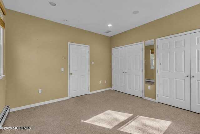 65 Pineoaka Rd, Jackson, NJ 08527 - unfurnished bedroom with light colored carpet, baseboards, two closets, and baseboard heating