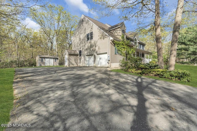 65 Pineoaka Rd, Jackson, NJ 08527 - view of side of home with a storage shed, driveway, an outdoor structure, and a garage