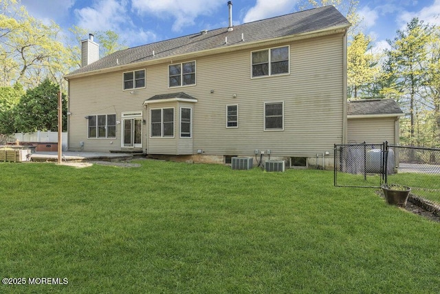 65 Pineoaka Rd, Jackson, NJ 08527 - rear view of property featuring a lawn, a patio area, fence, and a chimney