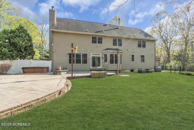 65 Pineoaka Rd, Jackson, NJ 08527 - back of property with fence, a chimney, a patio area, a lawn, and a hot tub