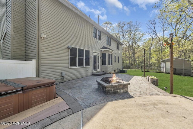 65 Pineoaka Rd, Jackson, NJ 08527 - rear view of property with central air condition unit, a hot tub, a patio area, a lawn, and a fire pit